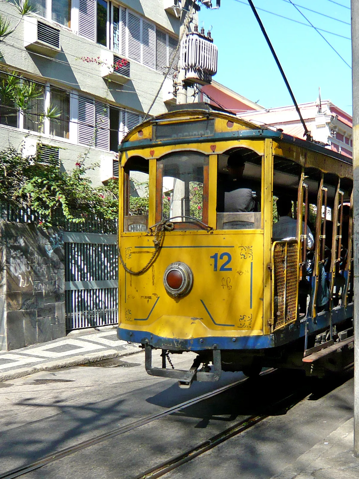 The yellow Santa Teresa tram on a sunlit street